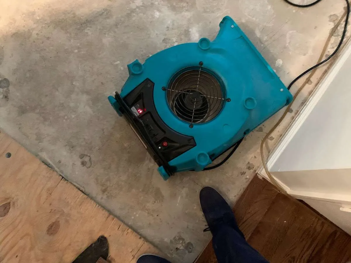 Air mover drying subfloor during Commercial Water Damage Restoration in Gas City